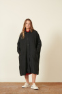 black coat, long and ample cut, with low armholes